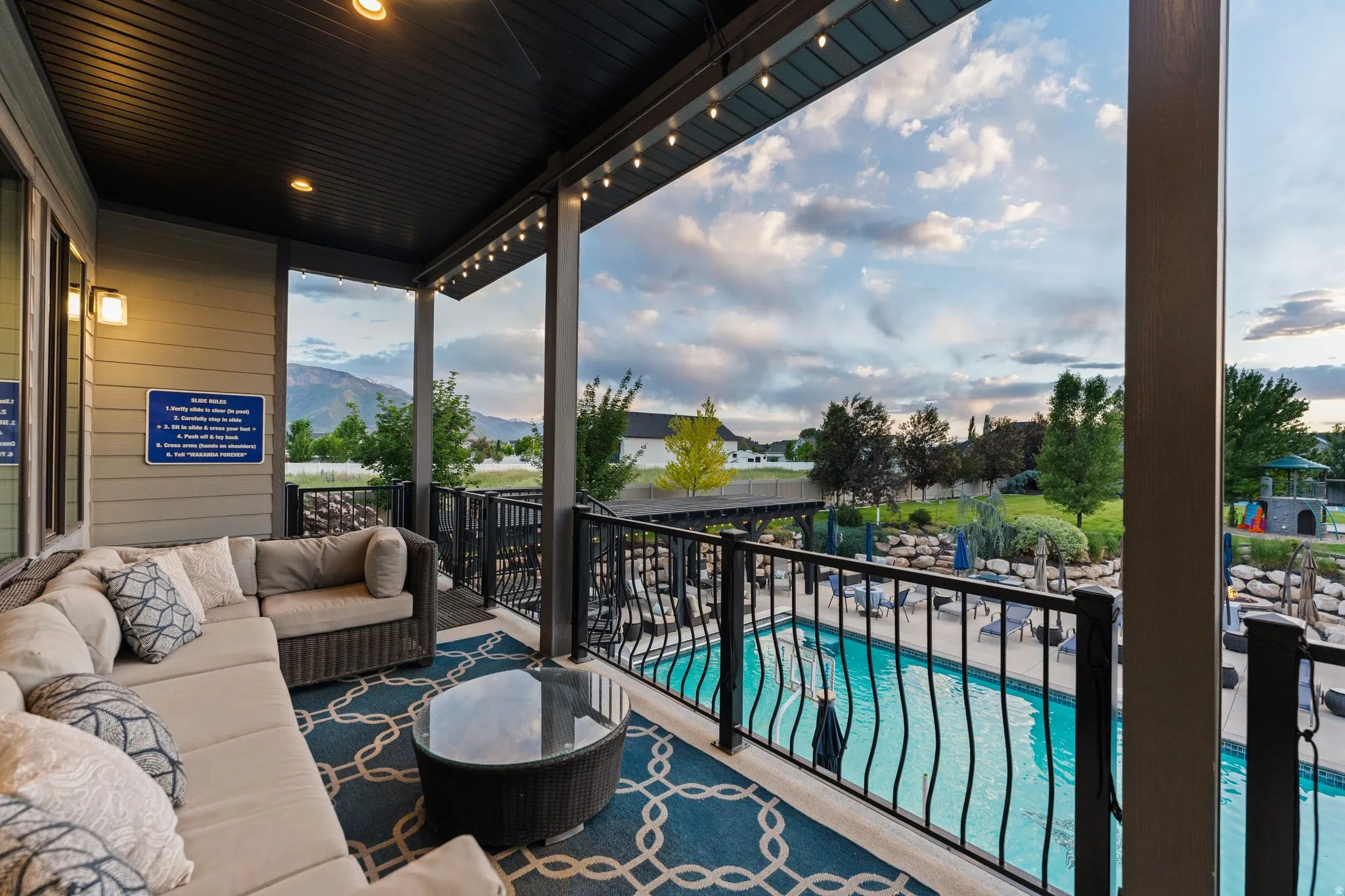 Covered outdoor patio featuring string lighting and a durable ceiling finish