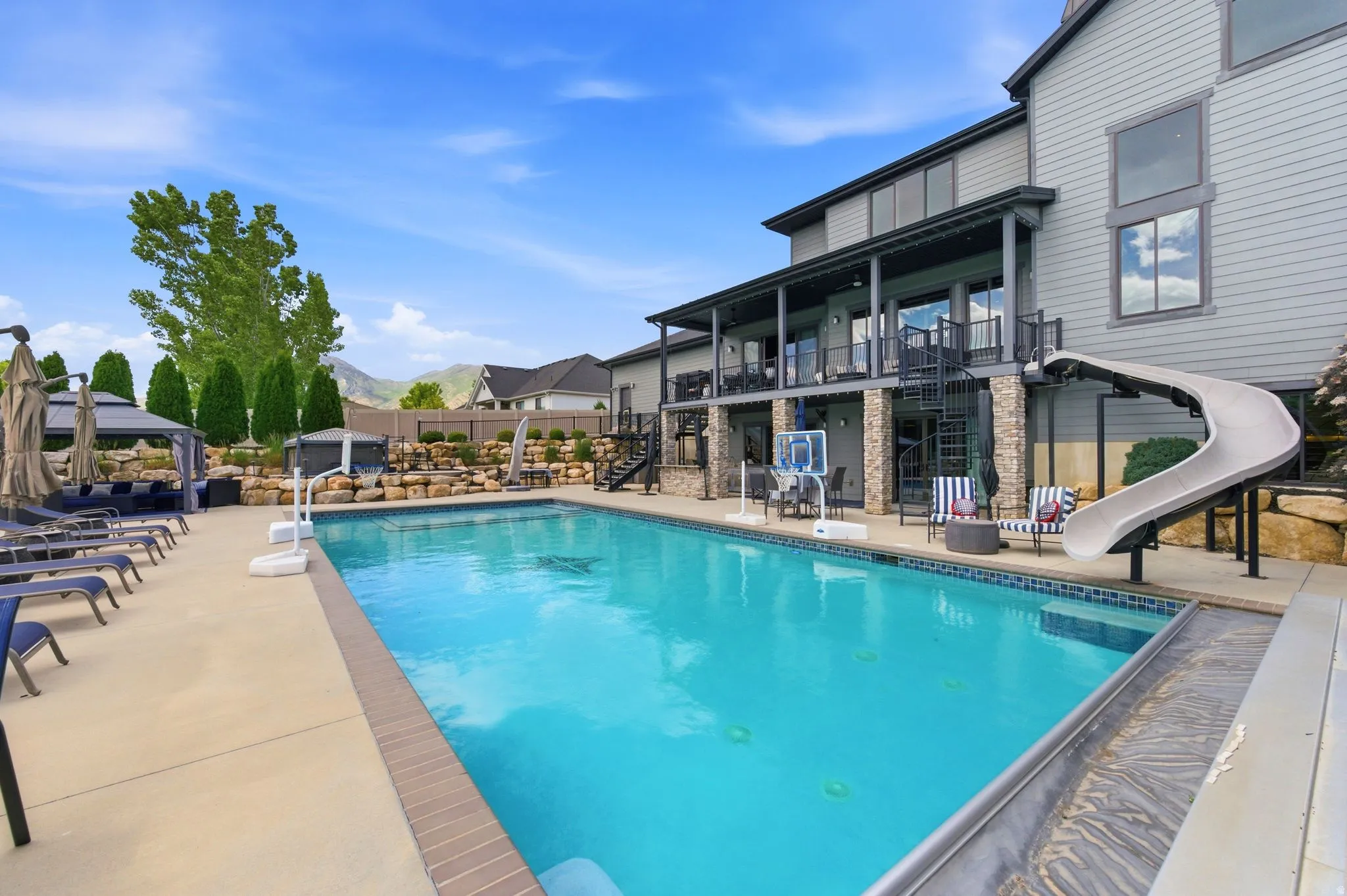 Expansive in-ground swimming pool with an integrated slide