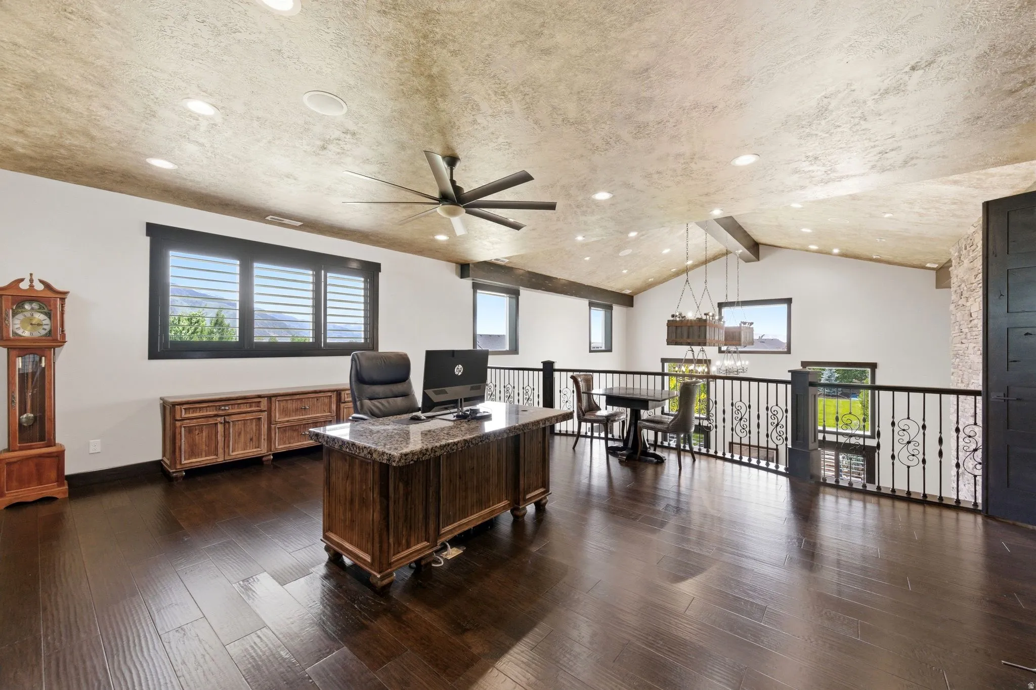 Vaulted ceiling with exposed beams, recessed lighting, and wood-finish flooring
