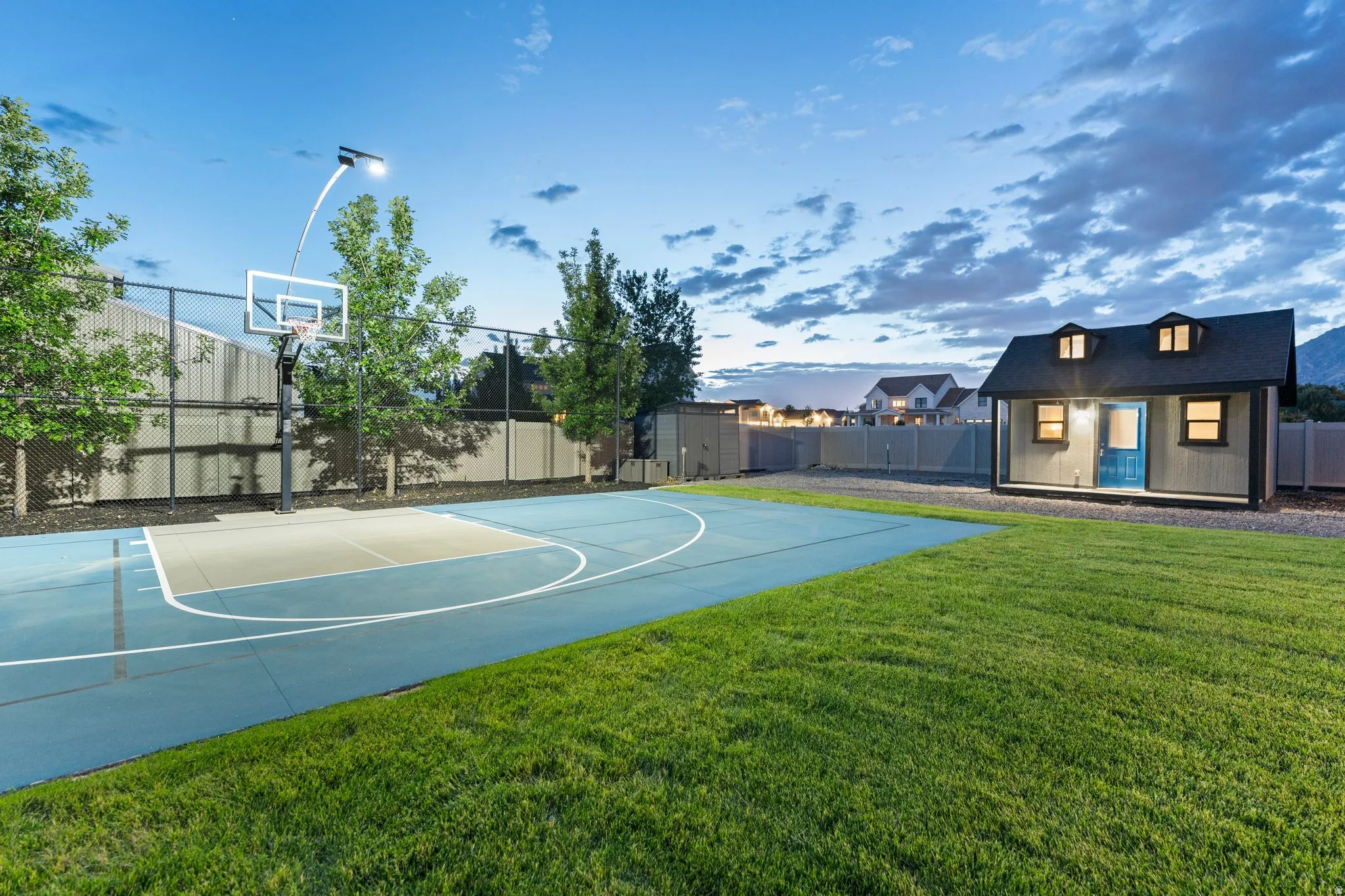 Outdoor sport court with a light blue surface and white demarcation lines