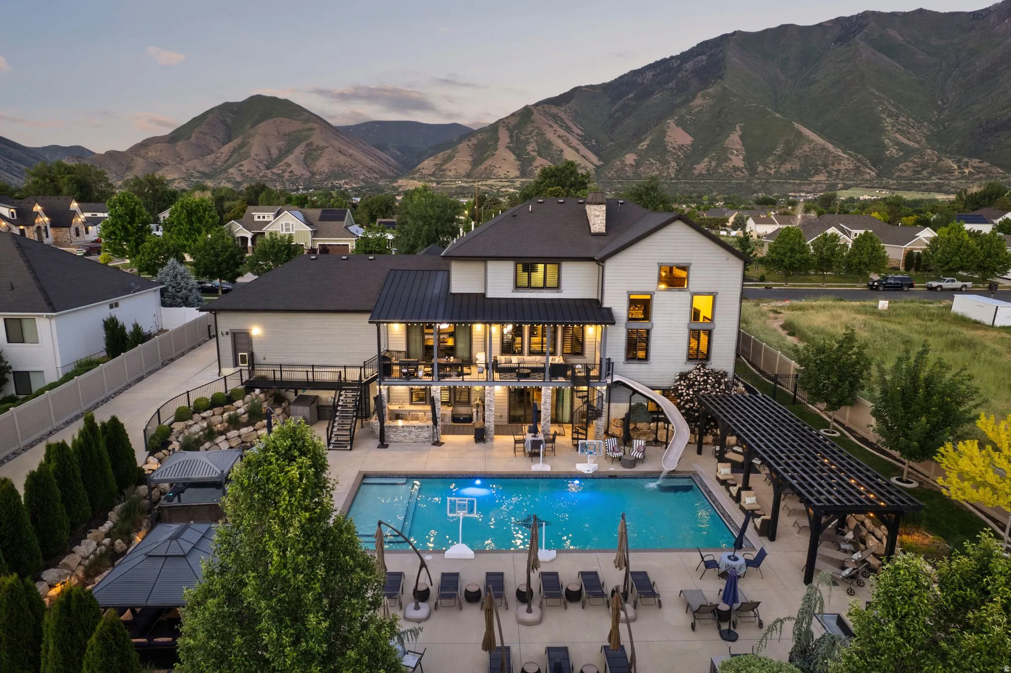 Modern two-story residence featuring a private pool with an integrated slide
