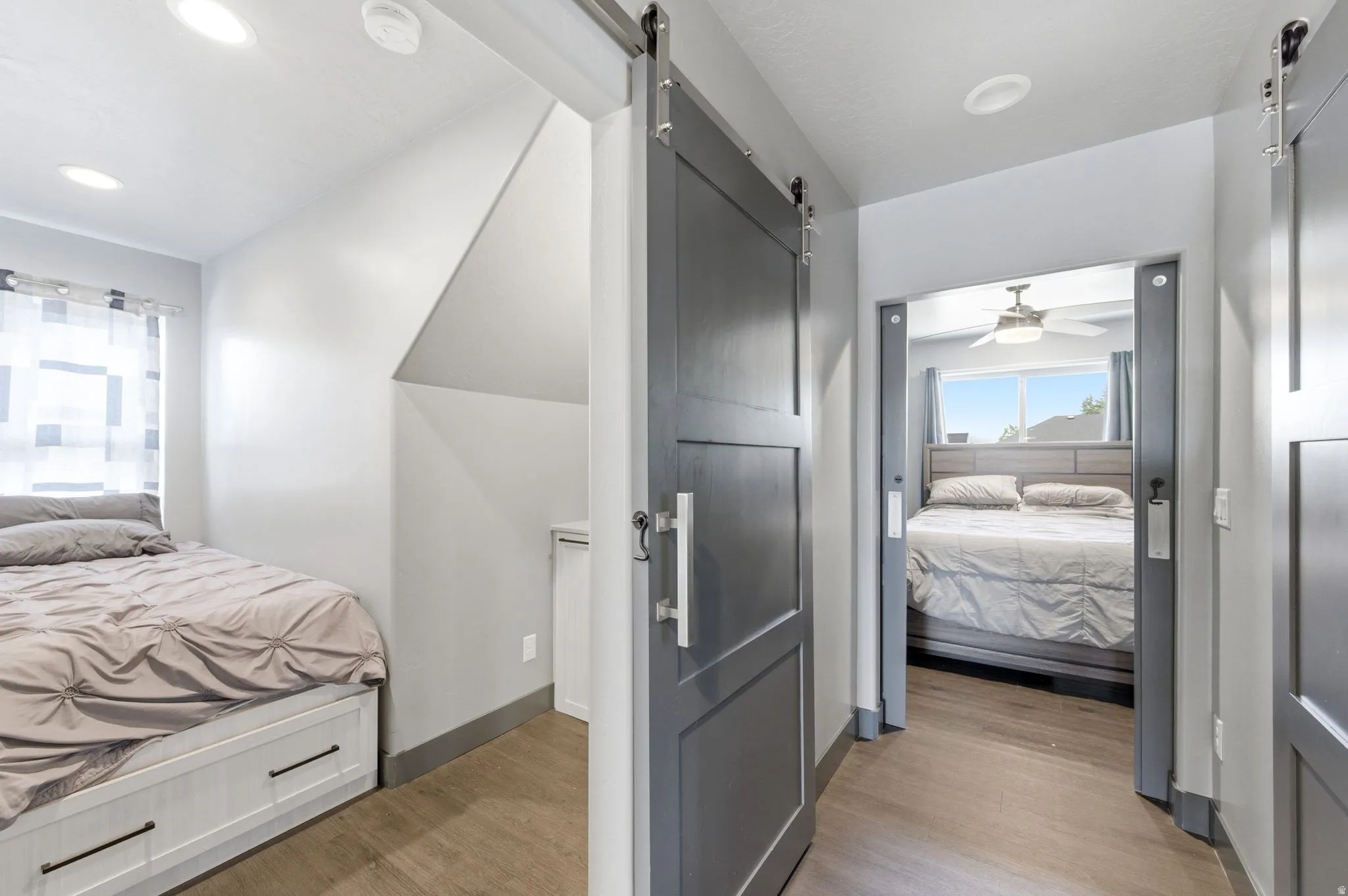 Interior hallway featuring wood-finish flooring and recessed lighting