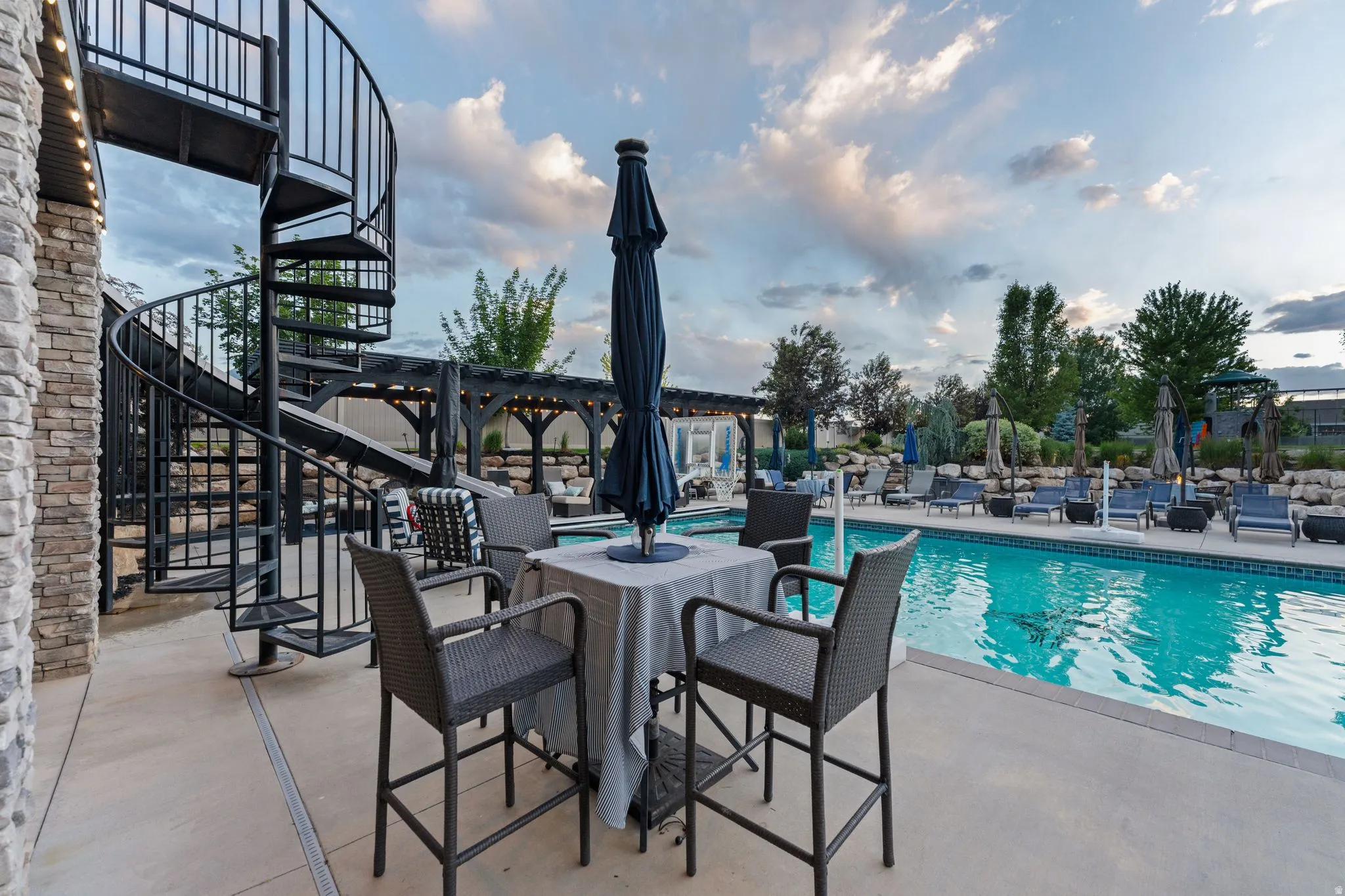 Exterior patio with a black metal spiral staircase