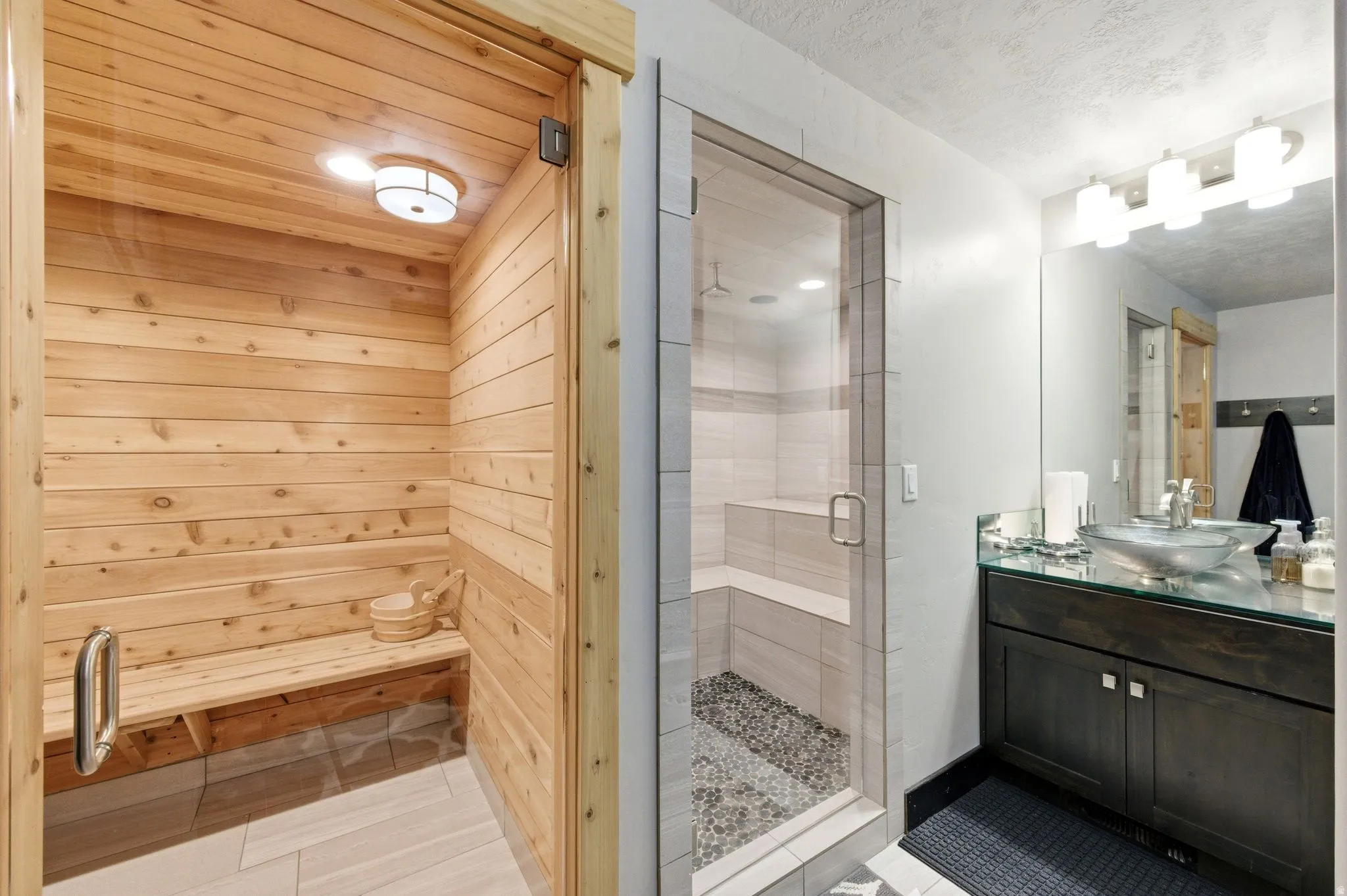 Sauna featuring wood plank walls and built-in bench seating