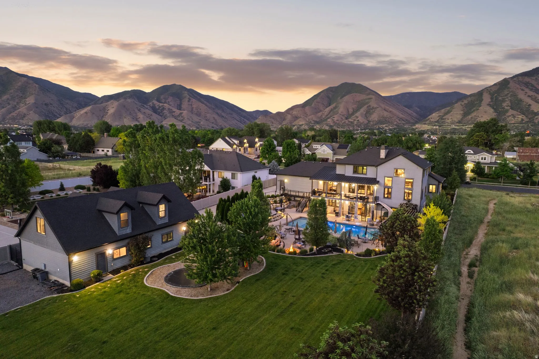 Expansive property featuring a spacious main residence, a detached auxiliary structure, and a large inground pool