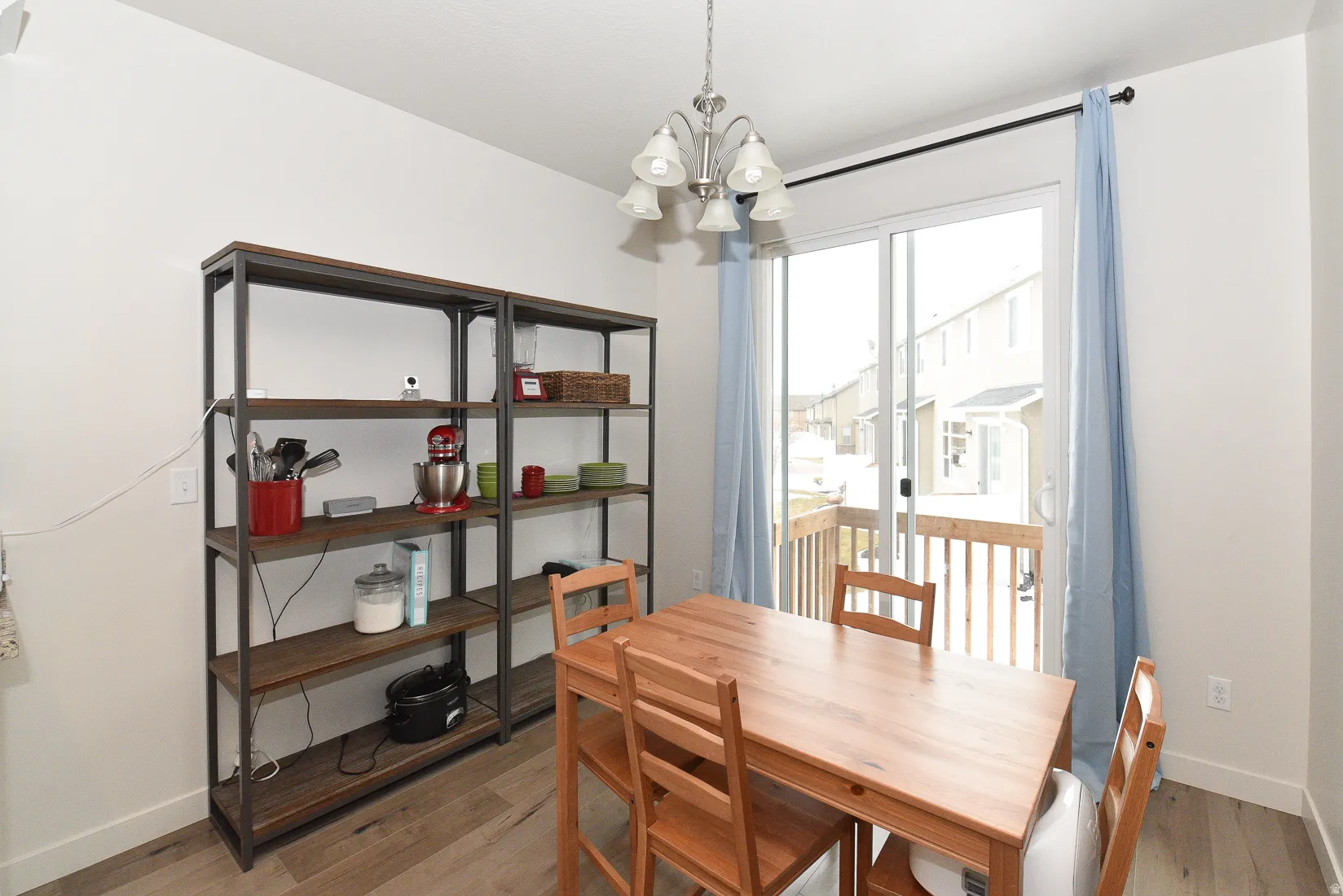 Dining area featuring wood-finish flooring and white baseboards