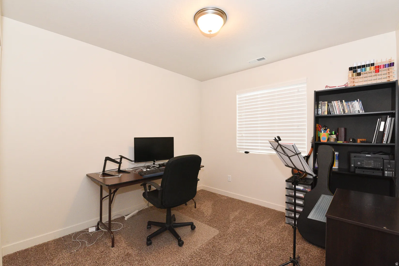 Room with neutral wall paint and brown carpet flooring