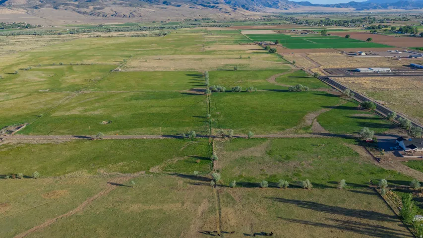 Expansive agricultural land featuring a mix of cultivated fields and green pastures