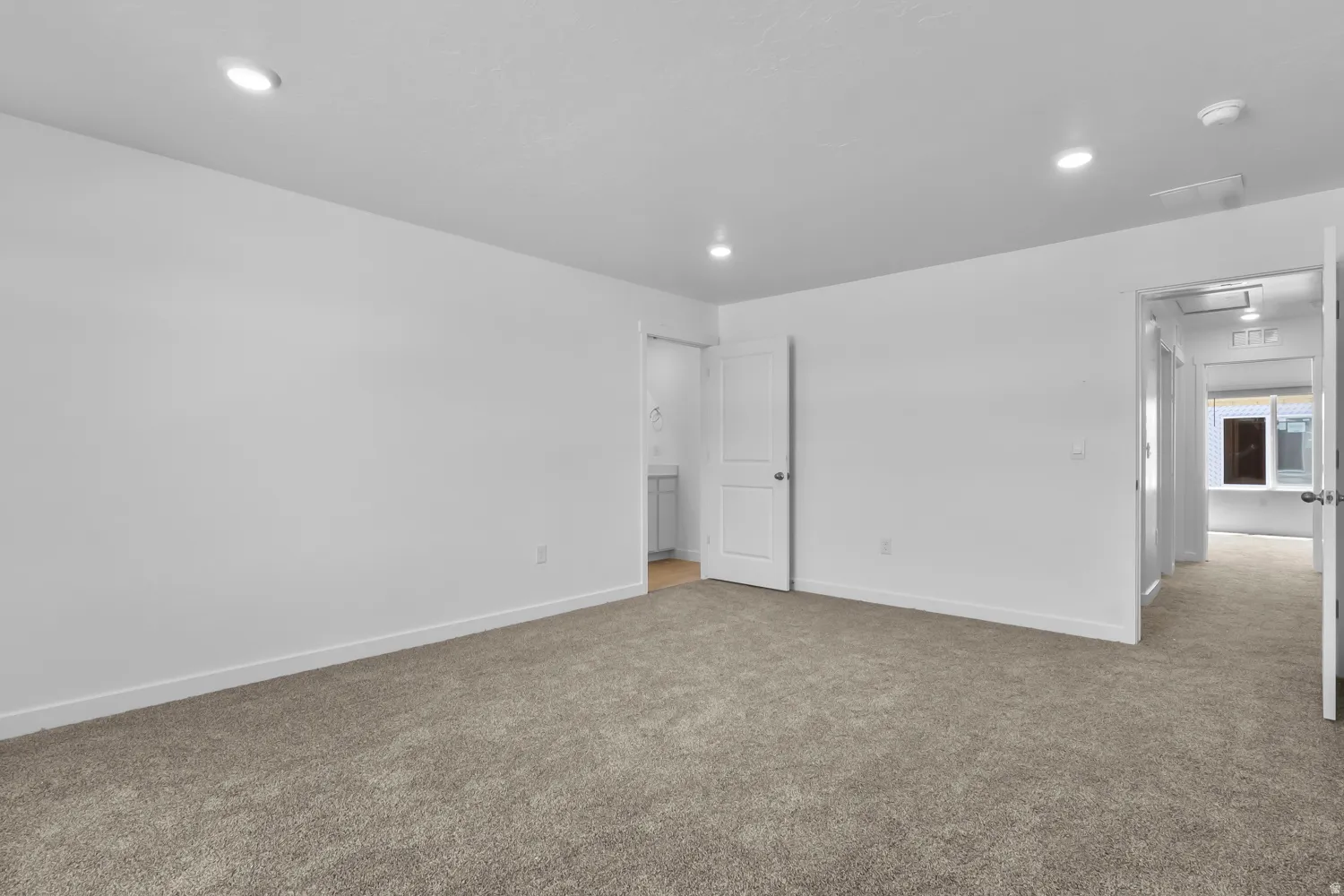 Spacious room with plush carpeting and recessed lighting