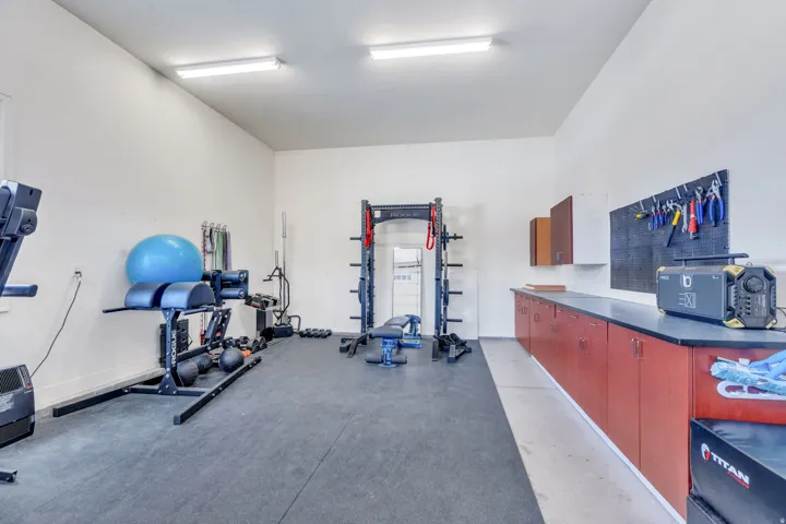 Spacious multi-purpose room featuring high ceilings and durable rubber flooring