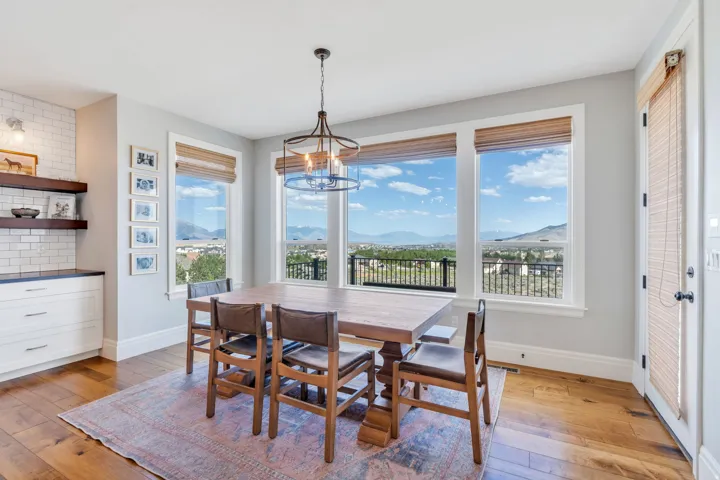 Dining area featuring hardwood flooring and a contemporary chandelier