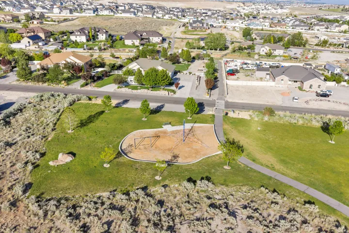 Community park with a dedicated playground area, paved walking paths, and mature landscaping