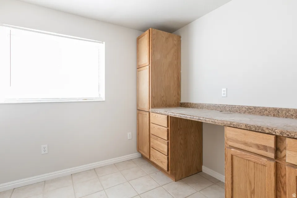 Built-in wood cabinetry with multiple drawers and upper storage