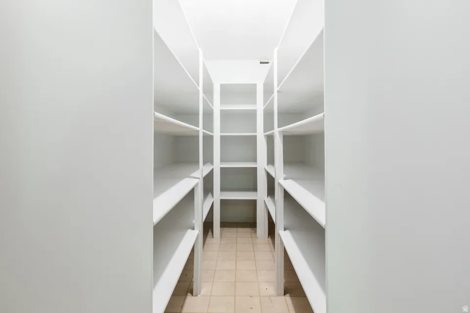 Walk-in pantry with extensive built-in shelving, providing abundant storage capacity