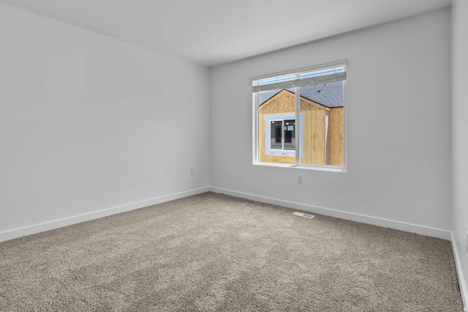 Neutral wall paint paired with plush gray carpeting