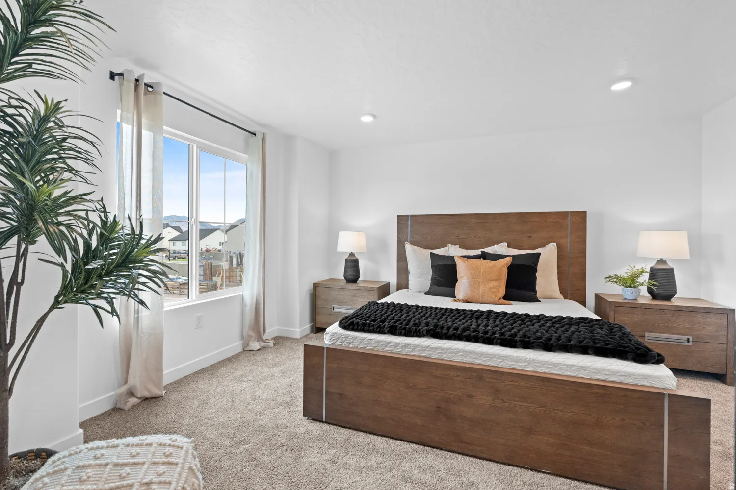 Bright bedroom featuring carpeted flooring and recessed lighting