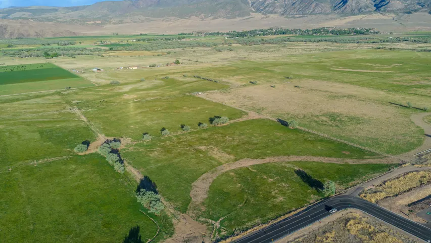 Expansive undeveloped land featuring a combination of green pastures and natural terrain