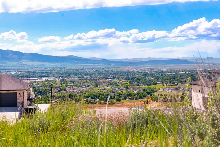 Elevated property featuring expansive distant mountain ranges and a valley with a community of homes and abundant trees
