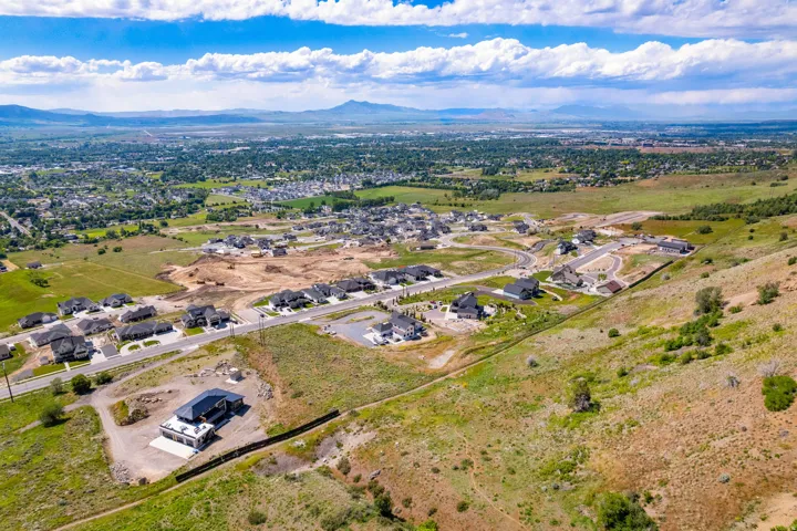 Expansive aerial perspective showcasing a developing residential community with varying stages of construction