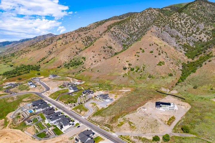 Aerial perspective showcasing a residential development nestled against a mountainous backdrop