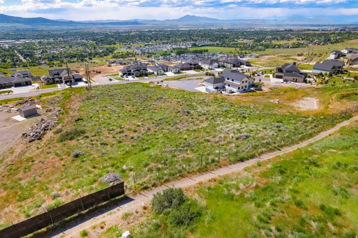 Expansive undeveloped lot featuring natural vegetation and mountain backdrops