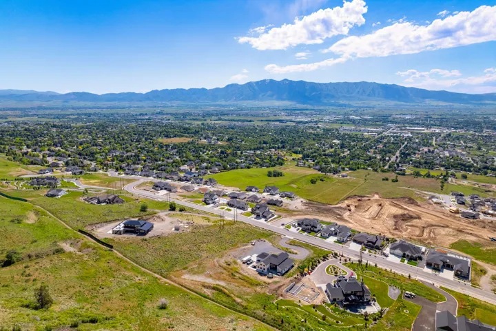 Sprawling residential development featuring varied architectural styles and an expansive mountainous backdrop