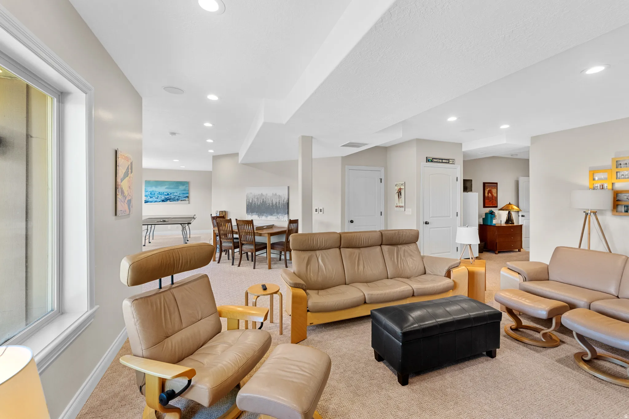 Spacious multi-purpose room featuring recessed lighting, light-toned carpeting, and a wide window opening
