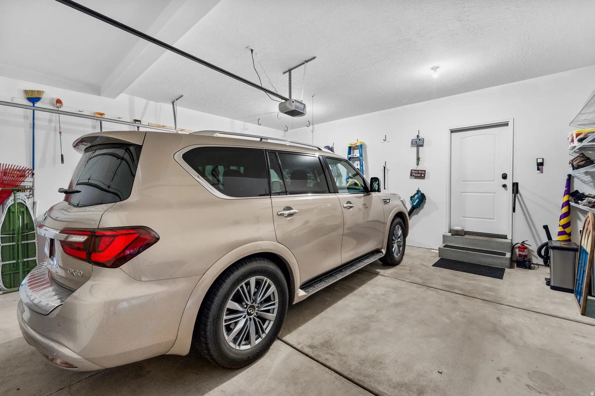 Spacious garage featuring a concrete floor, painted white walls, and an overhead garage door track system