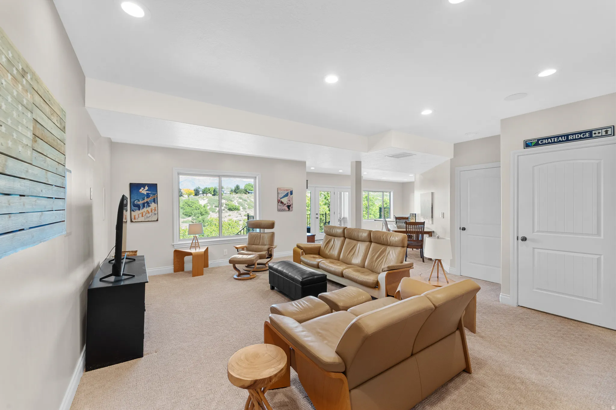 Spacious room featuring neutral carpeting and recessed lighting