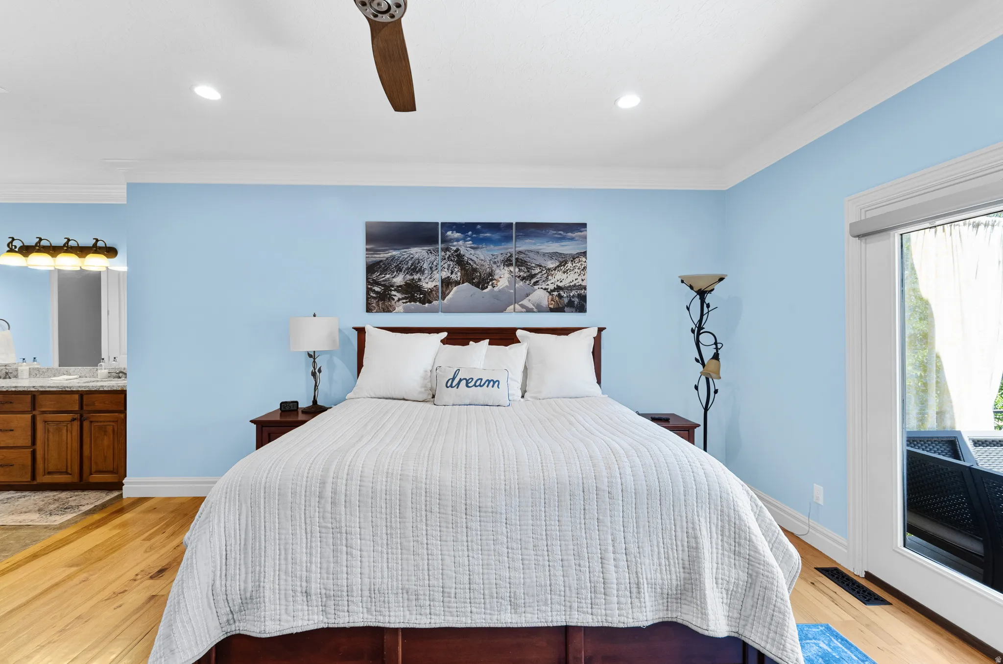 Light-filled room featuring wood-finish flooring, recessed lighting, and a ceiling fan