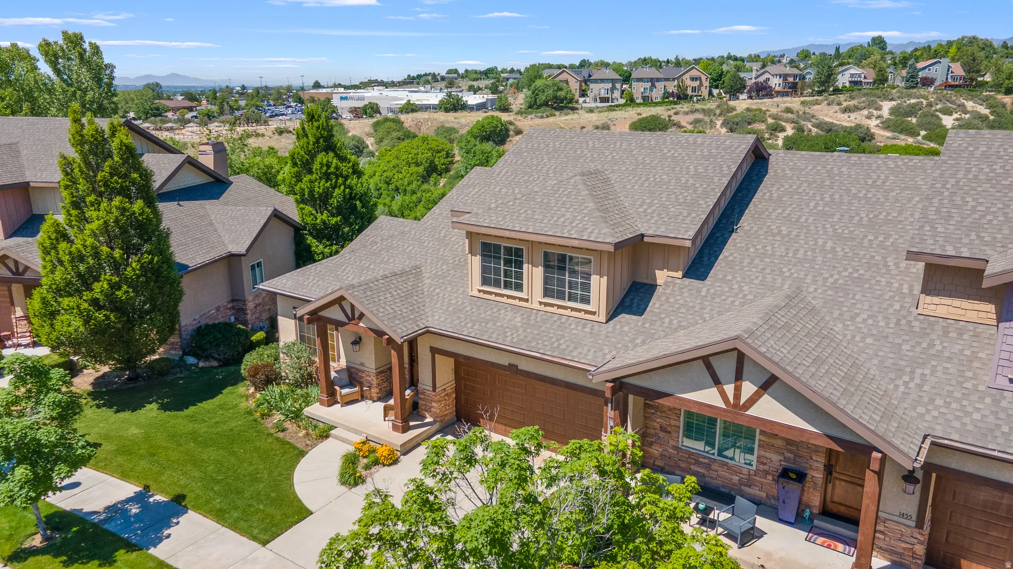 Craftsman-style exterior with stone and stucco accents, featuring an inviting covered porch