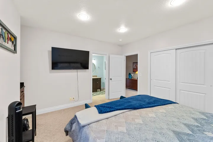 Carpeted bedroom featuring recessed lighting and white baseboards