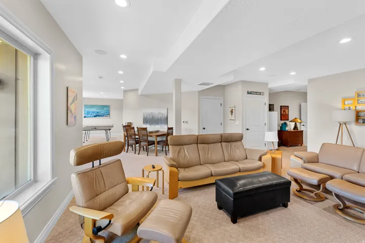 Spacious multi-purpose room featuring recessed lighting, light-toned carpeting, and a wide window opening
