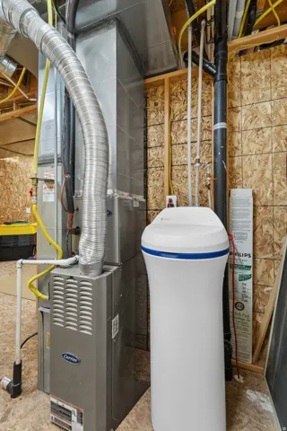 Carrier furnace and air handler system with visible ductwork and associated plumbing lines