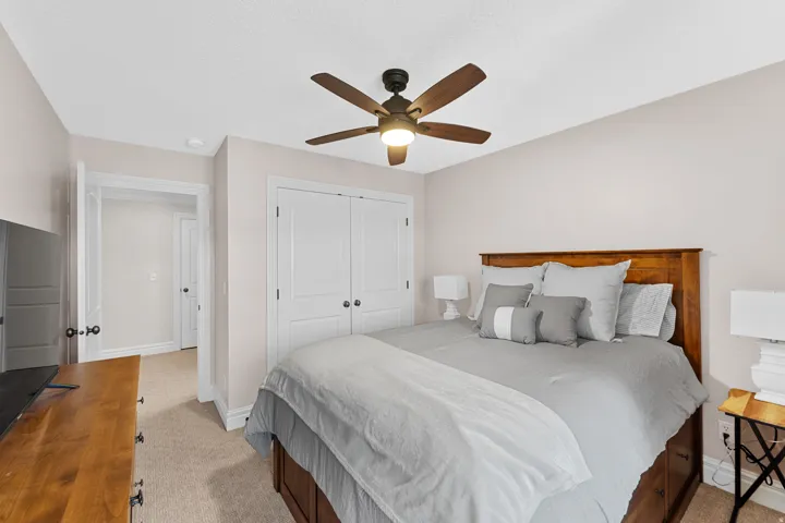 Neutral-toned room featuring light-colored walls and plush carpet flooring