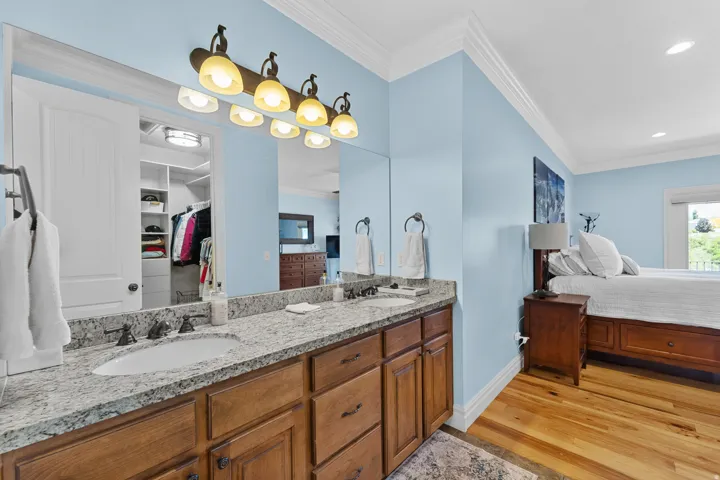 Spacious vanity area featuring a double sink with undermount basins and a granite countertop