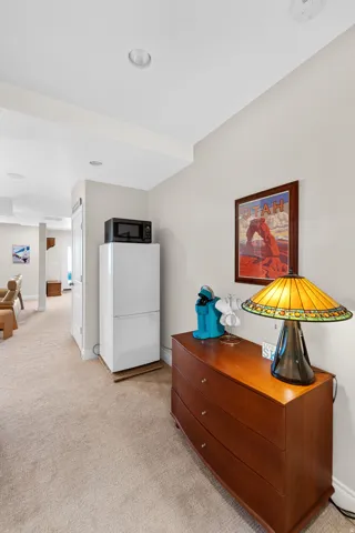 Carpeted hallway featuring recessed lighting and neutral wall tones