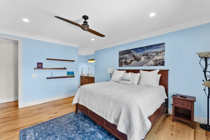 Hardwood-finish flooring featuring an overhead ceiling fan and recessed lighting