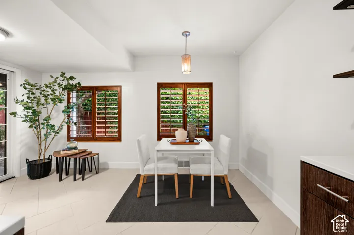 Dining area featuring light-toned tile flooring and white walls
