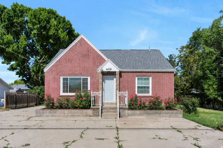 Brick exterior with a gray shingle roof