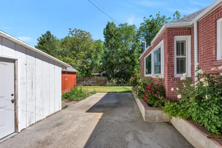 Concrete driveway leading to a white detached outbuilding