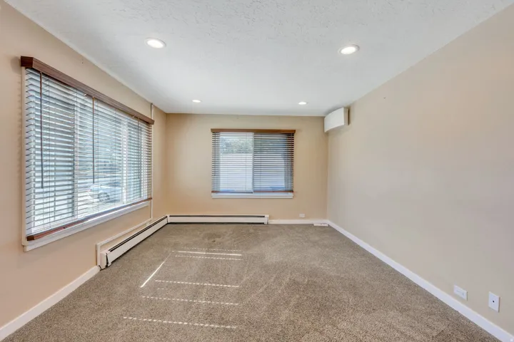 Spacious room with plush carpeting and neutral wall tones
