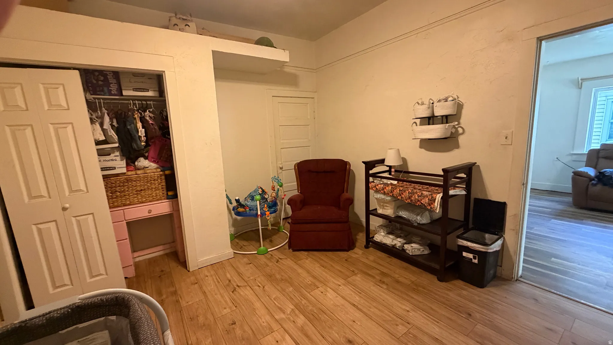 Room featuring wood-finish flooring and light-toned walls