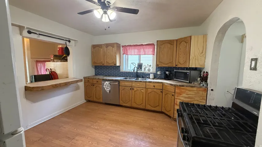 Kitchen featuring wood-finish flooring and light wood cabinetry