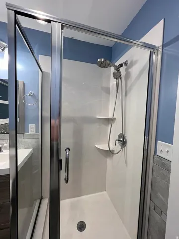 Full bathroom with vanity and a stall shower