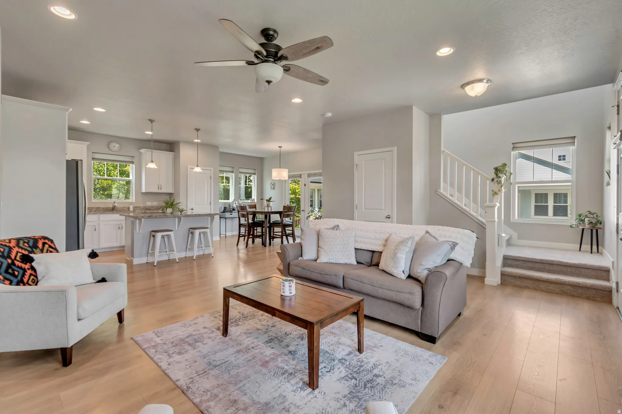 Notice how this living space flows seamlessly into the kitchen and dining areas.