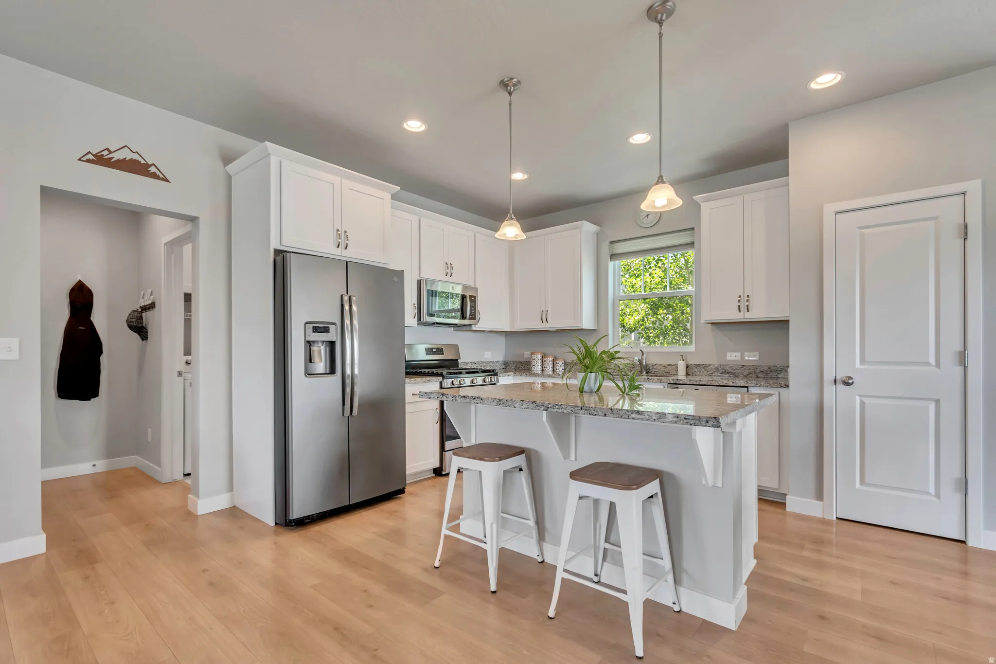 Modern kitchen with stainless appliances, granite counters and plenty of natural light.