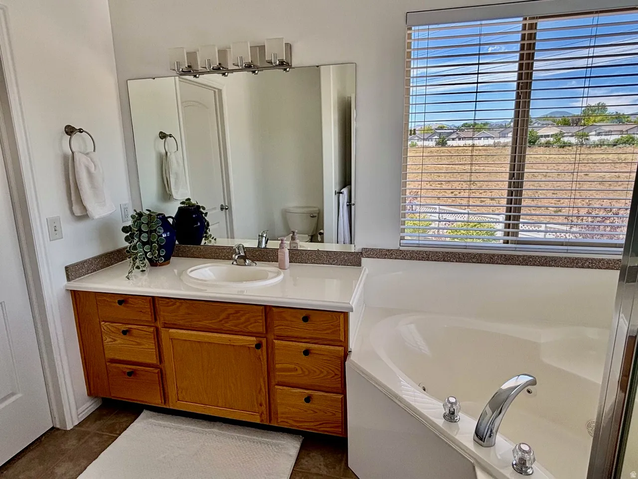 Single vanity, full tub, shower, walk-in closet