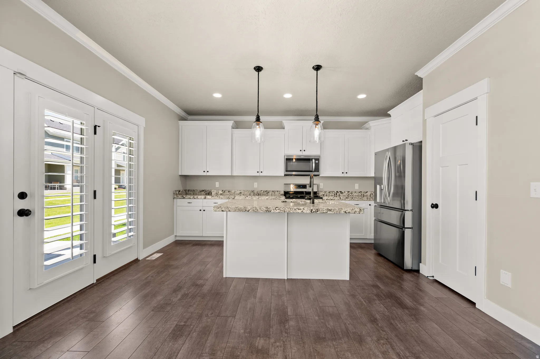 Modern kitchen with white cabinetry and stainless steel appliances