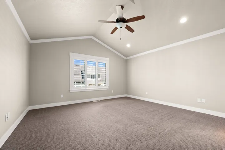 Vaulted ceiling with crown molding and recessed lighting